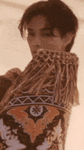 a close up of a person wearing a fringed jacket .