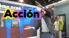 a man in front of a sign that says accion
