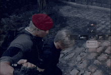 a man in a red hat is holding another man