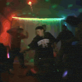 two men are dancing in front of a disco light