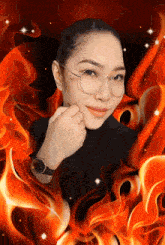 a woman wearing glasses is surrounded by fire