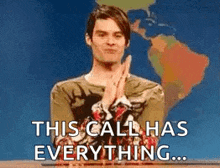 a man is sitting at a desk with his hands folded in front of a map of the world and says `` this call has everything ... ''