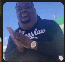 a man wearing a black shirt that says ' ns raw ' on it