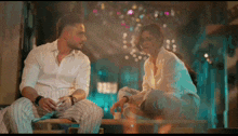 a man and a woman are sitting on a bench and talking to each other
