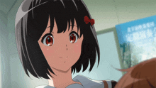 a girl with a red bow in her hair stands in front of a blue sign that says ' kyoto '