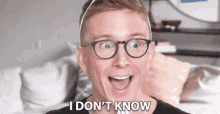 a man wearing glasses and a headband says " i don 't know " in front of his face