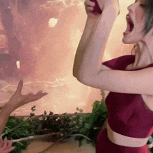 a woman in a red dress is screaming with her mouth wide open