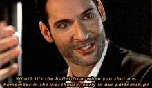 a man in a suit is smiling and holding a piece of paper that says what ? it 's the bullet
