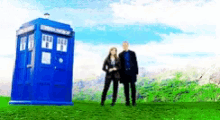 a man and woman standing in front of a blue box