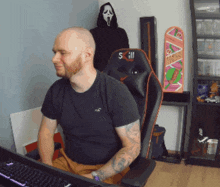 a man is sitting in a chair with the letter s on the back