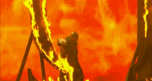 a man is riding a roller coaster that is surrounded by flames