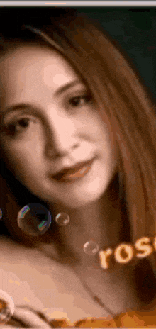 a close up of a woman 's face with soap bubbles surrounding it .