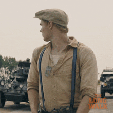 a man wearing suspenders and a hat with the long walk written on the bottom
