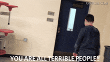 a gif from gifrun.com shows a boy standing in a hallway