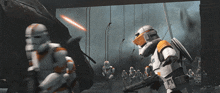 a group of stormtroopers are fighting each other and one of them has the word clones on his chest