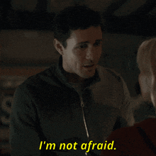 a man says i 'm not afraid while looking at a woman