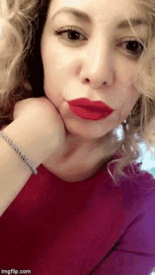 a close up of a woman 's face with red lipstick on her lips