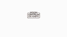 a woon centrum de knipe logo with a couch and table