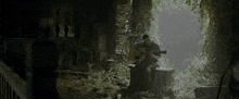a man is playing a guitar in a dark cave
