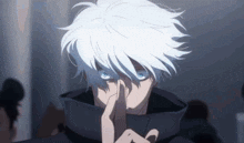 a man with white hair and blue eyes is holding his finger to his mouth