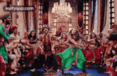 a group of people are dancing together in a room .