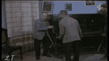 a group of men are standing in a room with a sign that says lt