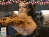 a woman holds a piece of food in her hand
