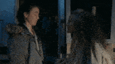 a man and a woman hugging each other in the dark