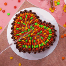 a heart shaped cake with candy on it