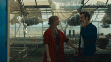 a man and woman are standing in a greenhouse with a big bold beautiful journey written on the bottom