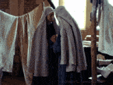 two nuns are standing next to each other in front of clothes hanging on a clothes line and a tumblr.com link is below them