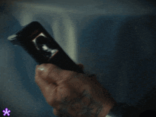 a person with a tattoo on their arm is holding a target device