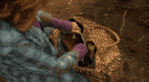 a woman with red hair is holding a gun in her right hand