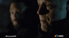 two men are looking at each other with a chicagopd logo in the corner