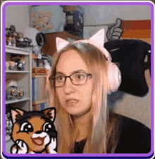 a woman wearing cat ears and headphones looks at a cartoon cat .