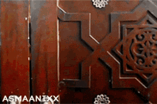 a close up of a wooden door with the name asmaanixx on the bottom right