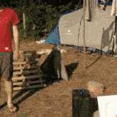 a man standing in front of a tent that says quechua