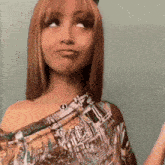 a woman making a funny face is wearing a colorful shirt