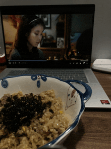 a bowl of food sits in front of a laptop that says amd on the bottom