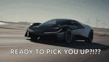 a black and white sports car is driving down a road with the words " ready to pick you up " written below it