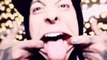 a close up of a person making a funny face with their tongue sticking out .