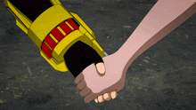 a person holding another person 's hand with a yellow and red object behind them