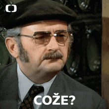 a man wearing glasses and a hat has the word coze written on his face