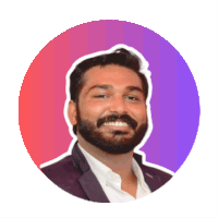 a man with a beard is smiling in front of a purple and red circle