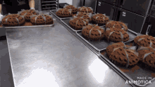 a bunch of cupcakes on a tray with the words made in animatica on the bottom right