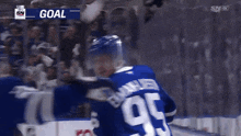 a hockey player in a blue jersey with the number 95 on it