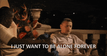 a man sitting on a couch with the words i just want to be alone forever