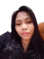 a woman with long black hair is sitting in a chair