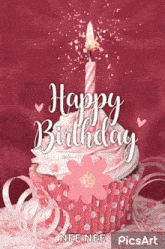 a pink cupcake with a candle and a flower on it .