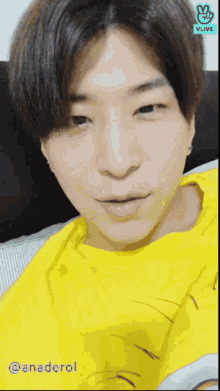 a close up of a person 's face with a vlive logo behind them
